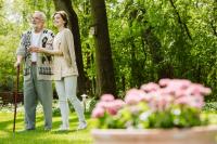 Une femme aide et accompagne un vieil homme