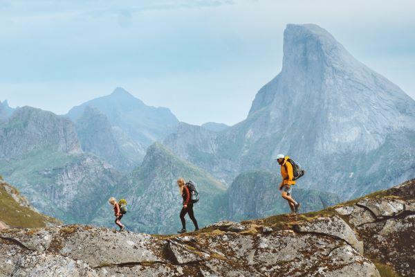 Famille faisant une randonnée ensemble en montagne, des vacances en plein air. 